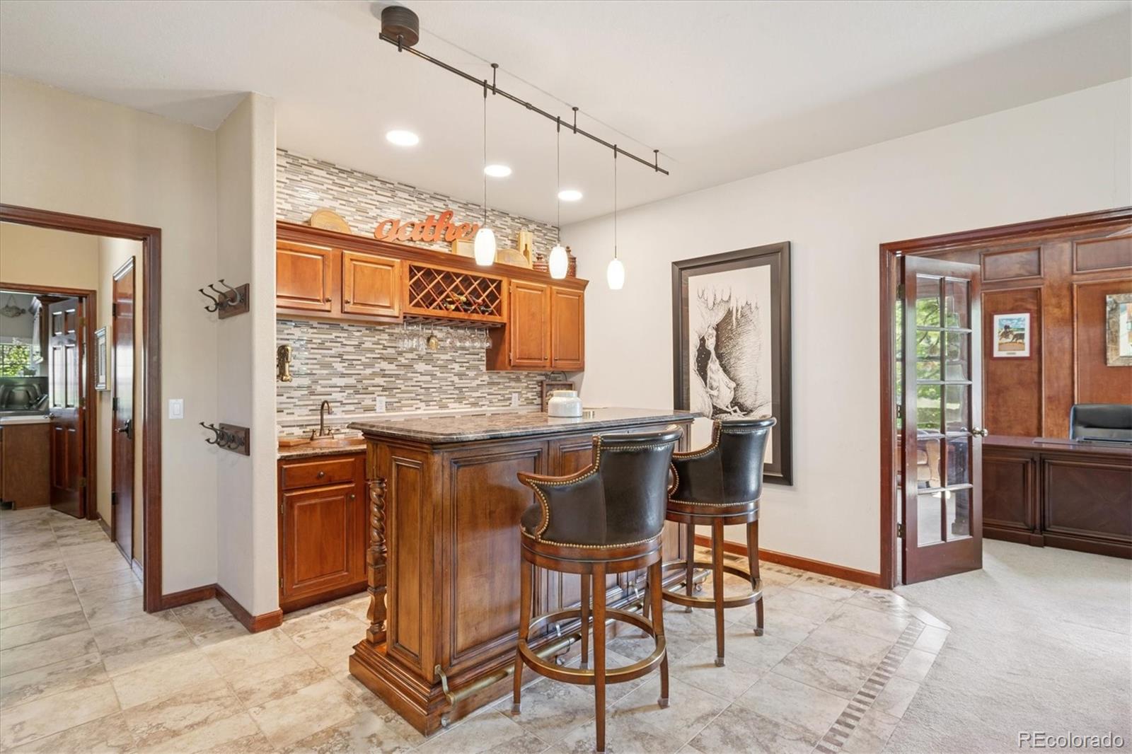 7804 Silverweed Way Lone Tree, CO 80124 - Photo 5 of 32 a kitchen with stainless steel appliances kitchen island granite countertop dining table chairs cabinets and sink