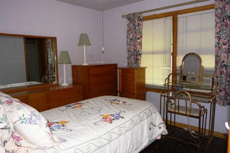 10851 Oak Avenue Chicago Ridge, IL 60415 - Photo 8 of 15 a bedroom with a bed and dresser with mirror