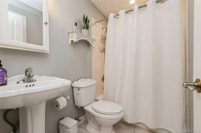 a white toilet sitting next to a white sink