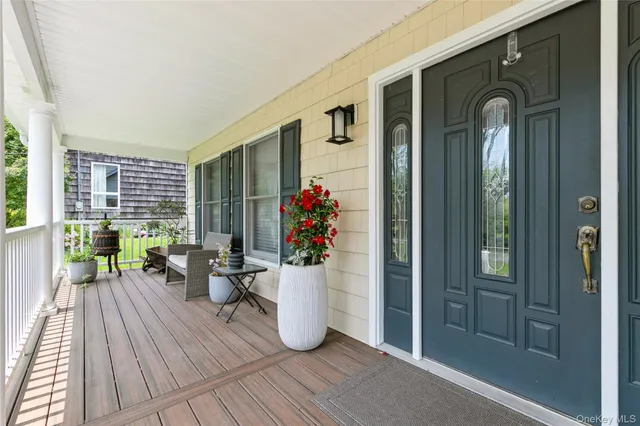 a view of a porch with wooden floor and dining room