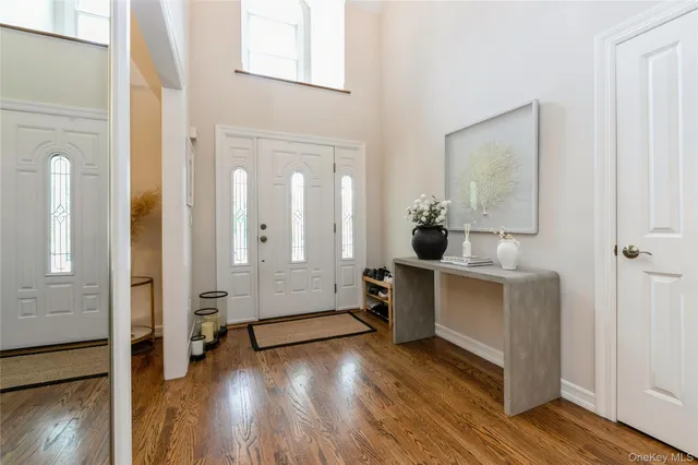 a room with a mirror and a wooden floor