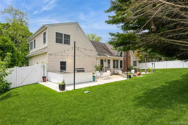a view of a house with backyard and sitting area