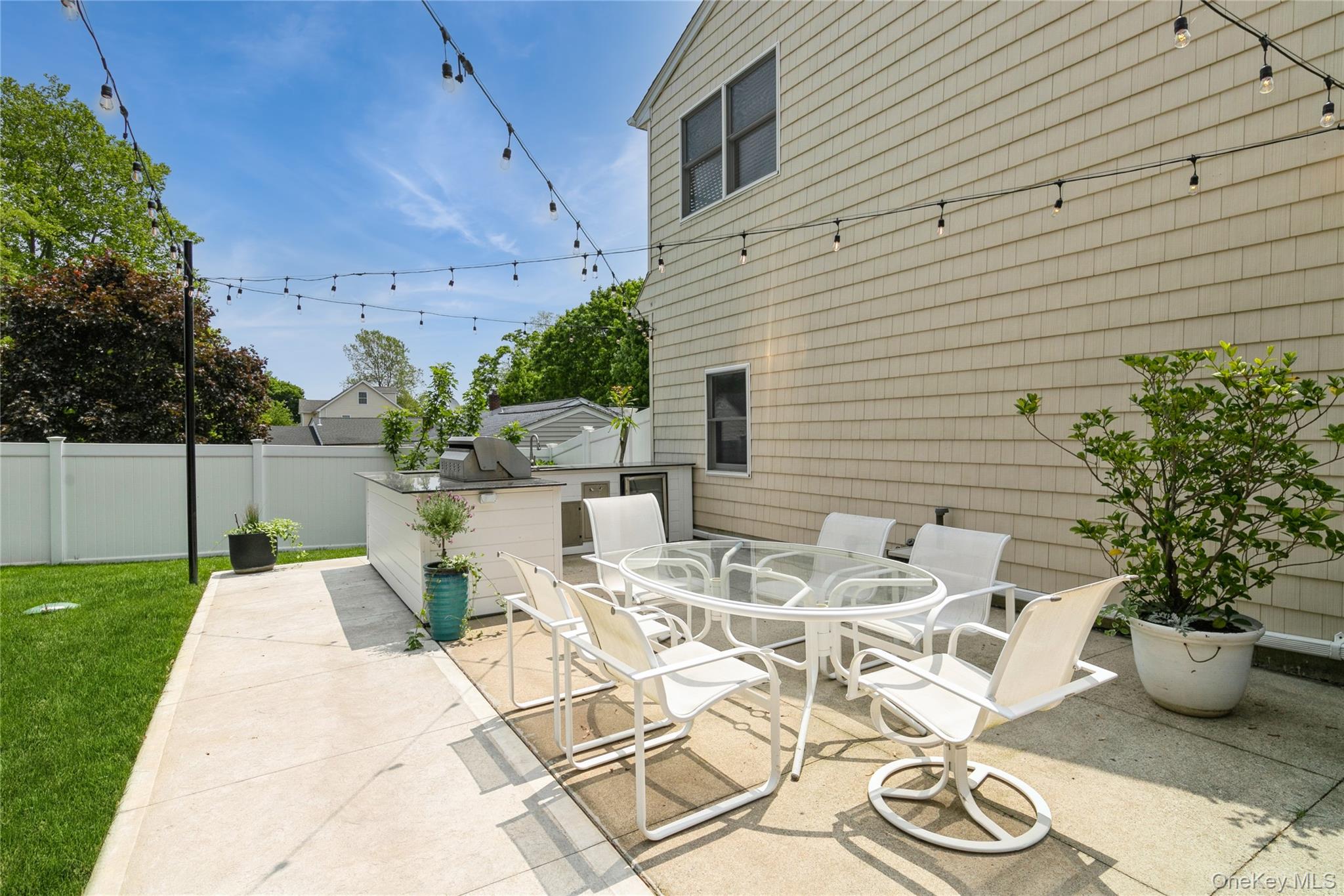 800 Ruth Road Mattituck, NY 11952 - Photo 28 of 29 a view of a patio with table and chairs potted plants and large tree