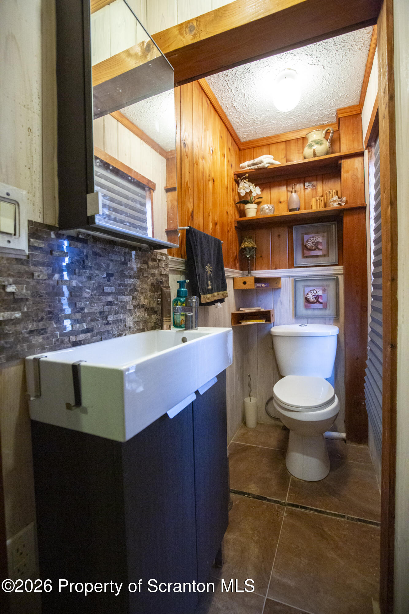 3245 Cedar Avenue Scranton, PA 18505 - Photo 29 of 37 a bathroom with a toilet a sink and a mirror