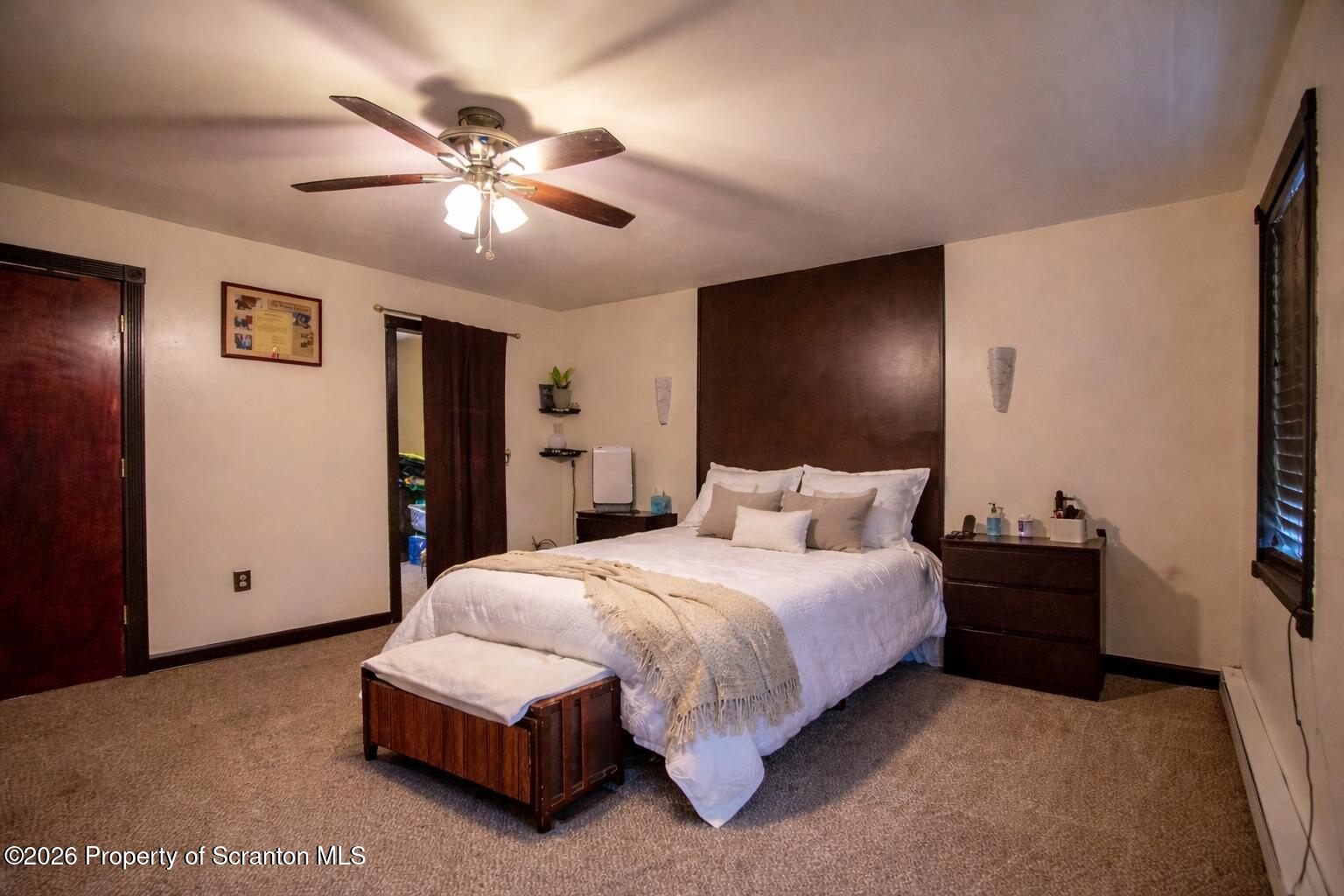 3245 Cedar Avenue Scranton, PA 18505 - Photo 30 of 37 a spacious bedroom with a bed and a chandelier