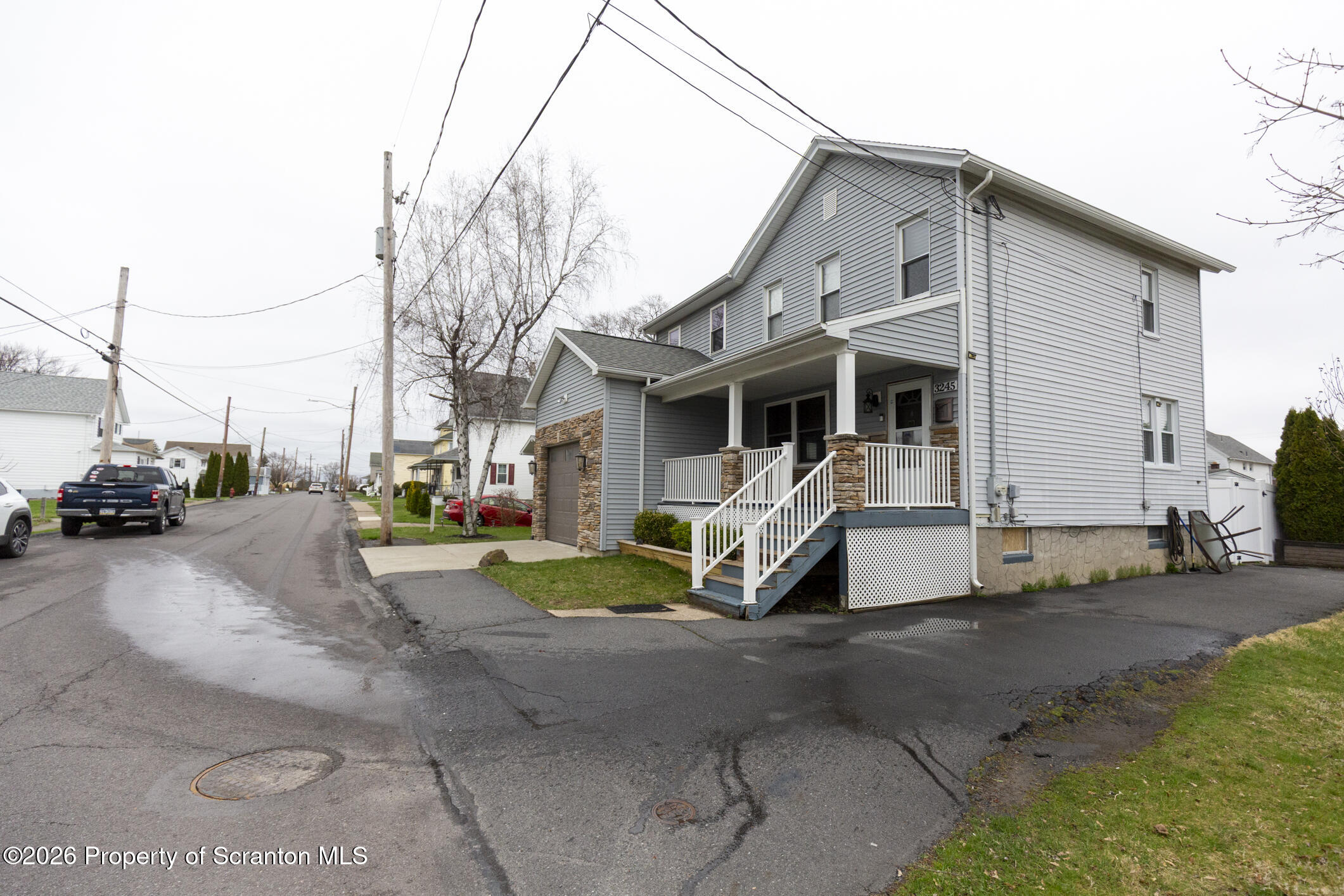 3245 Cedar Avenue Scranton, PA 18505 - Photo 3 of 37 a view of a white house with large windows next to a road