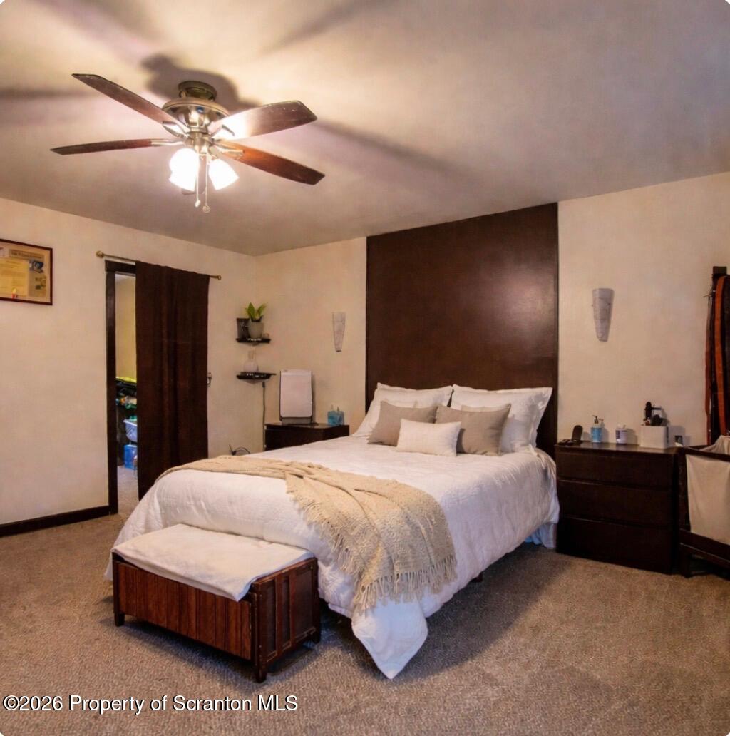 3245 Cedar Avenue Scranton, PA 18505 - Photo 32 of 37 a bedroom with a bed and lamp with window