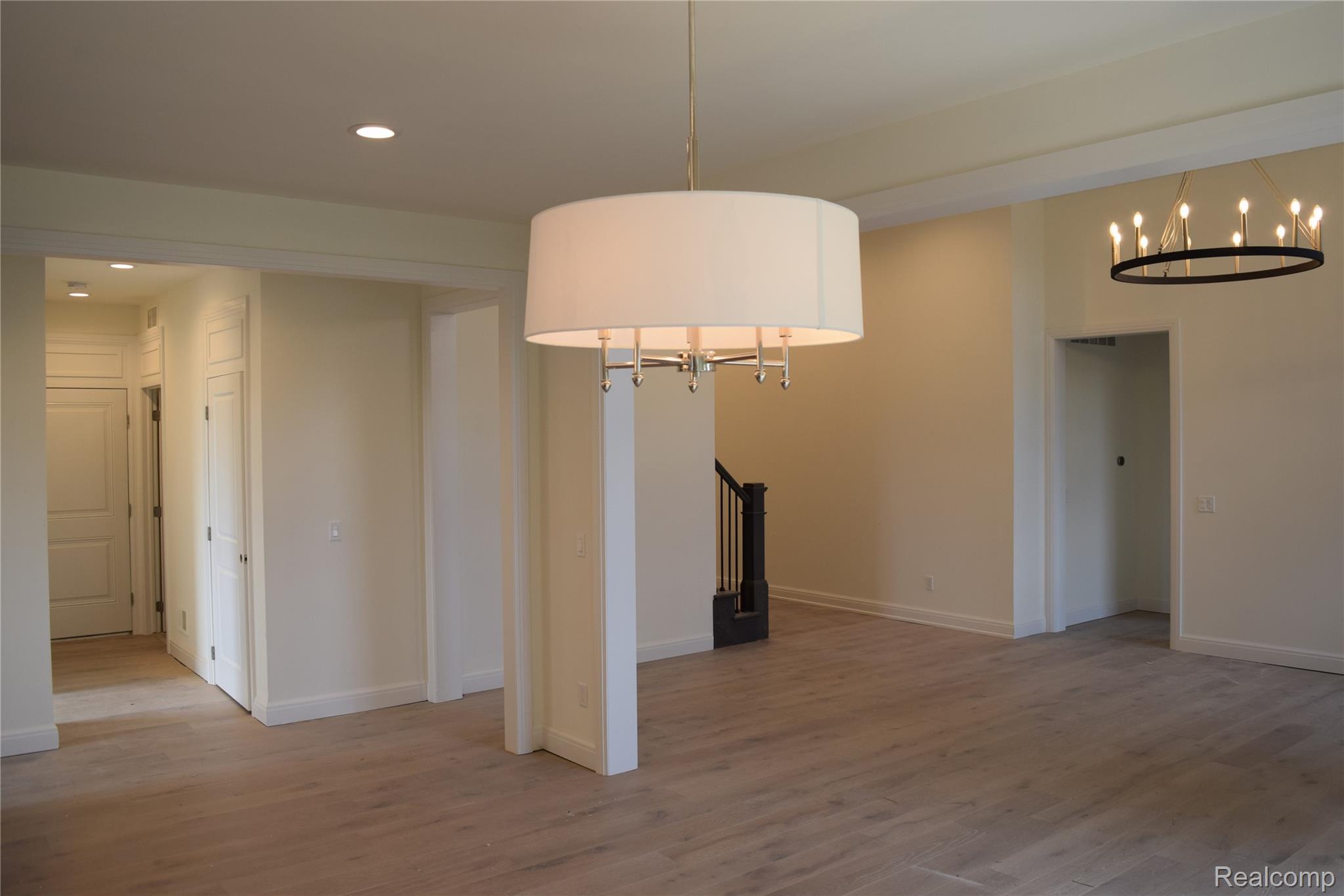 3093 Raffler Drive Rochester, MI 48307 - Photo 20 of 34 Unfurnished dining area with a chandelier, light wood flooring, recessed lighting, and stairway