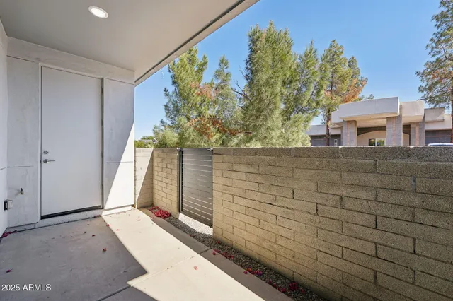 a bathroom with a toilet a sink and glass door