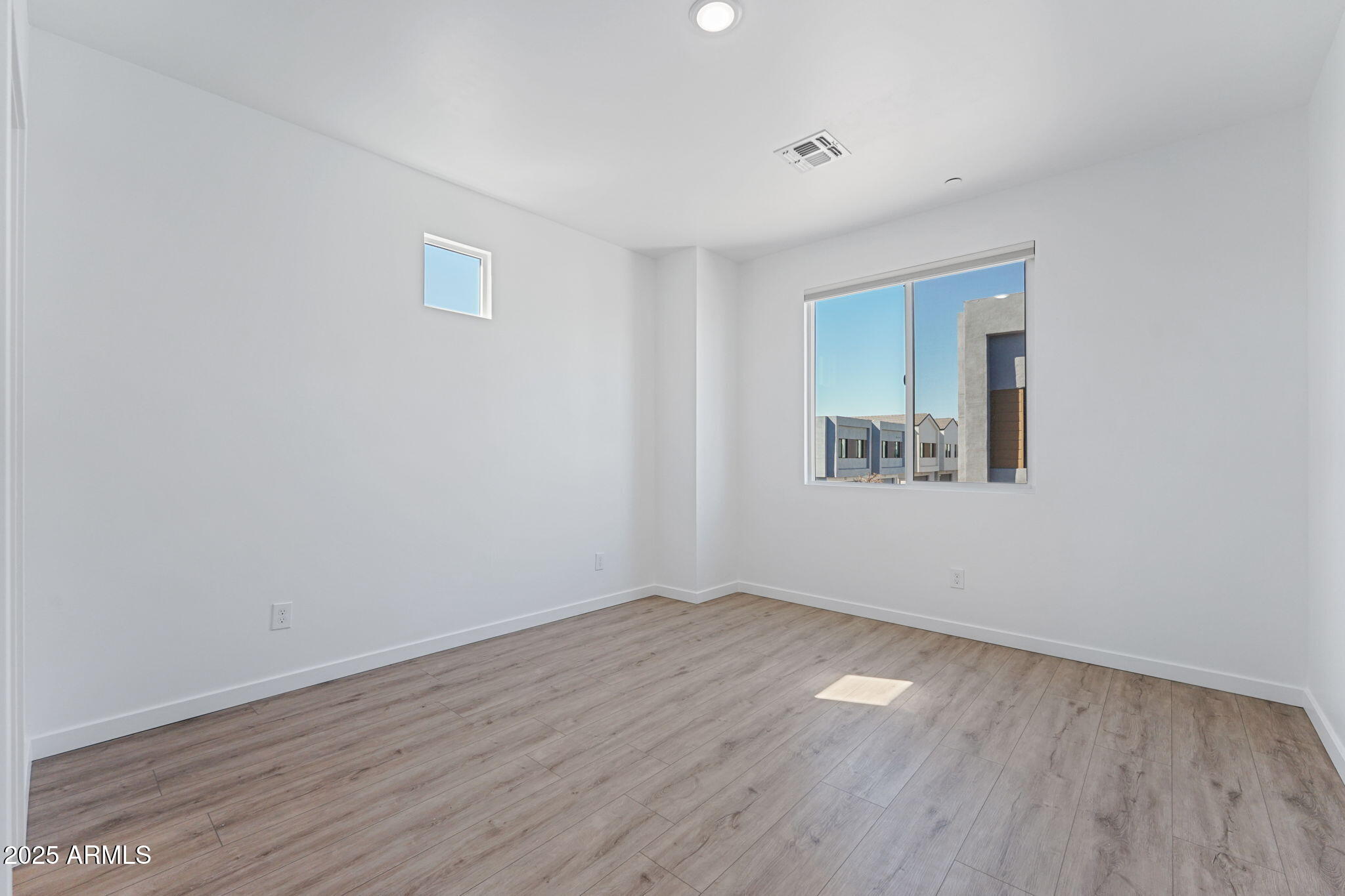 225 North Pleasant Drive, Unit 30 Chandler, AZ 85225 - Photo 13 of 34 a view of an empty room with wooden floor