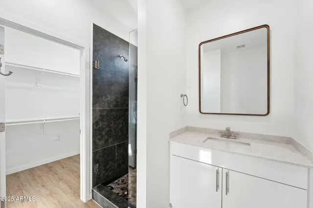 a bathroom with a double vanity sink and a mirror