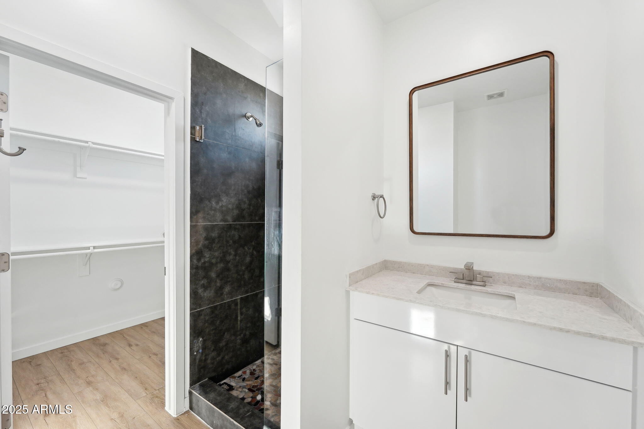 225 North Pleasant Drive, Unit 30 Chandler, AZ 85225 - Photo 17 of 34 a bathroom with a granite countertop sink a mirror and shower