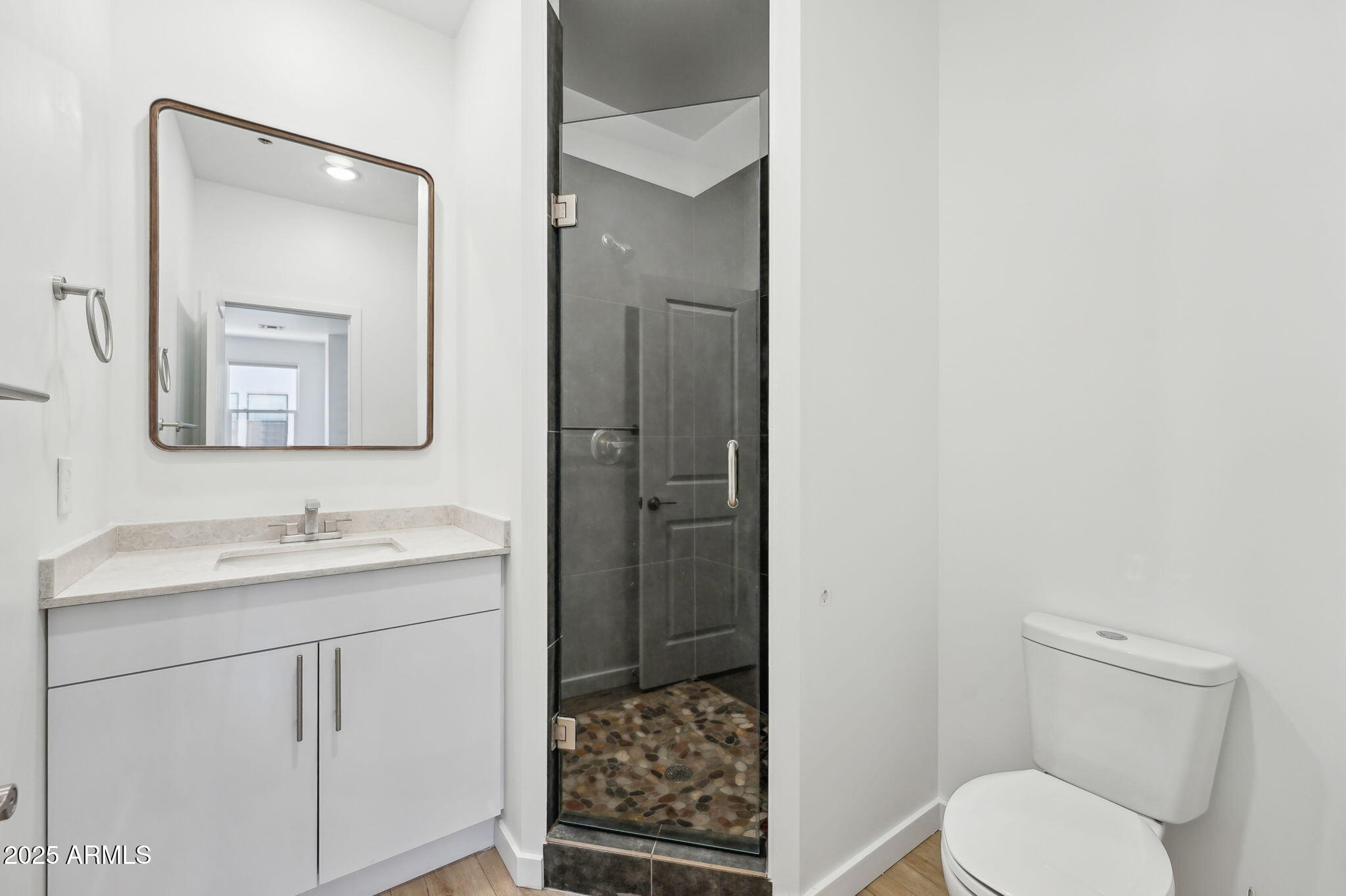 225 North Pleasant Drive, Unit 30 Chandler, AZ 85225 - Photo 20 of 34 a bathroom with a toilet sink vanity and mirror