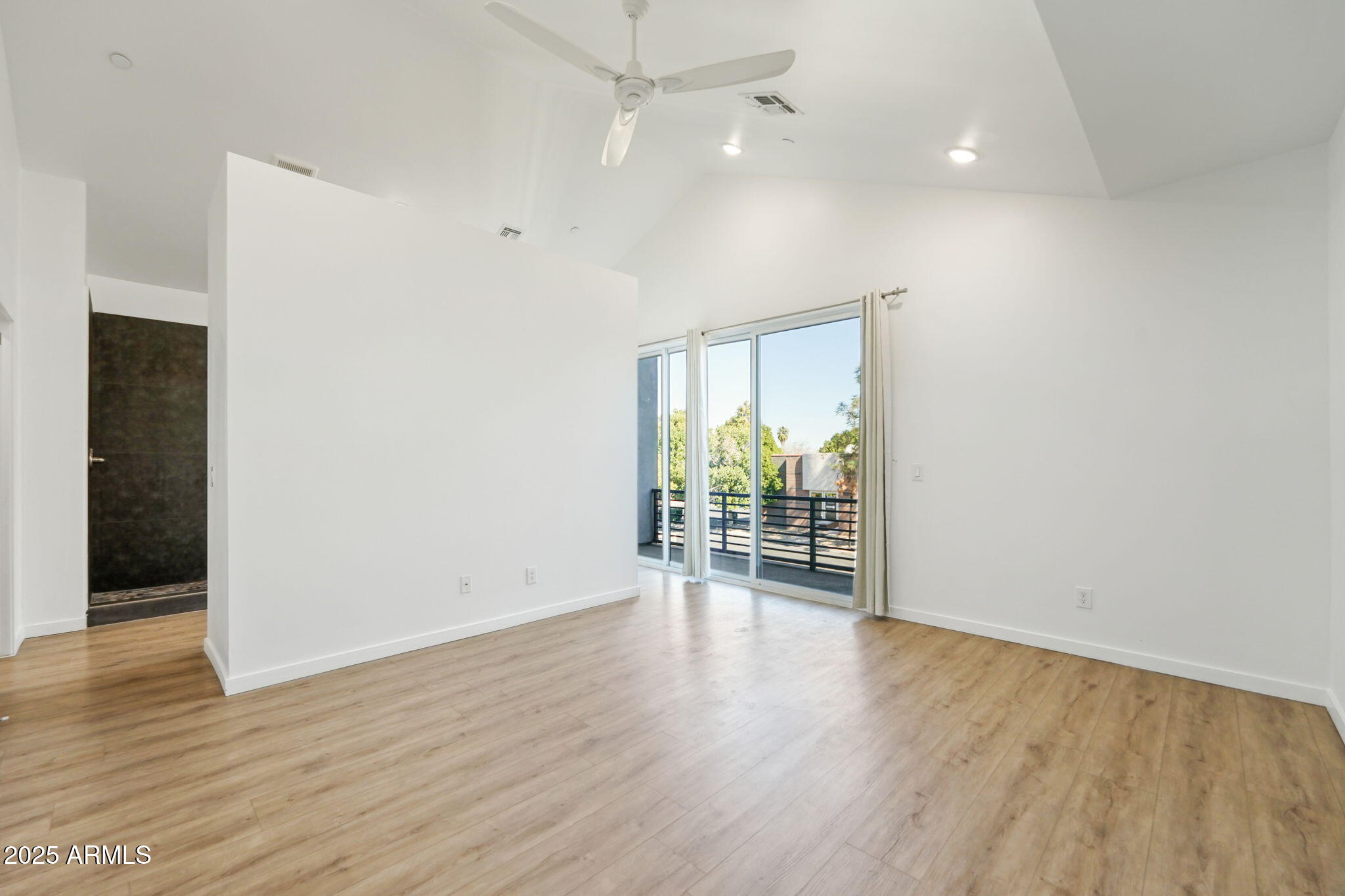 225 North Pleasant Drive, Unit 30 Chandler, AZ 85225 - Photo 21 of 34 an empty room with wooden floor and natural light