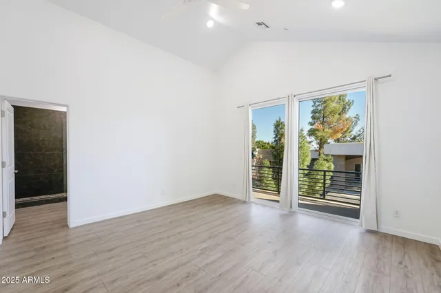an empty room with windows and closet