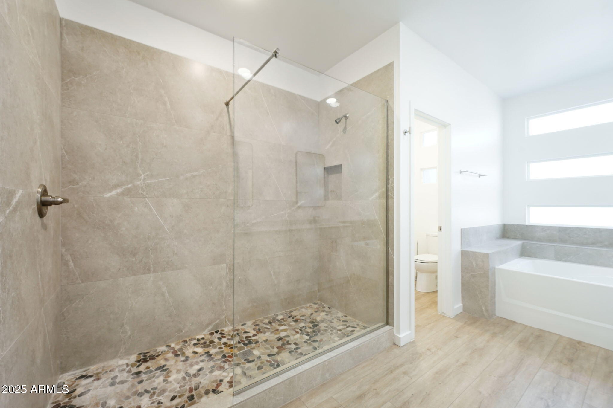 225 North Pleasant Drive, Unit 30 Chandler, AZ 85225 - Photo 28 of 34 a bathroom with a bathtub and a shower