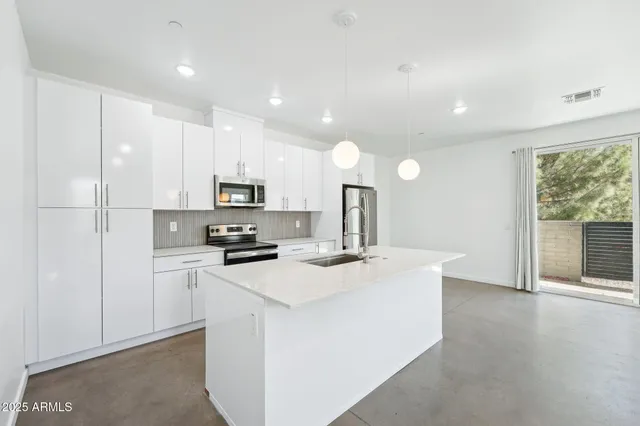 a bathroom with a glass shower door and a sink