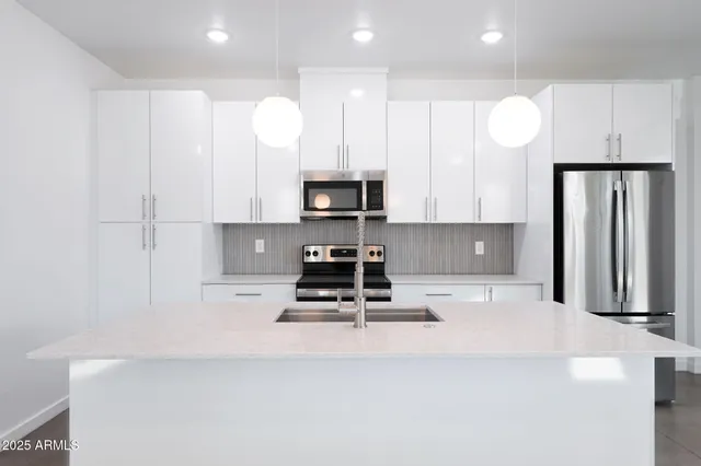 a bathroom with a granite countertop sink a mirror and shower