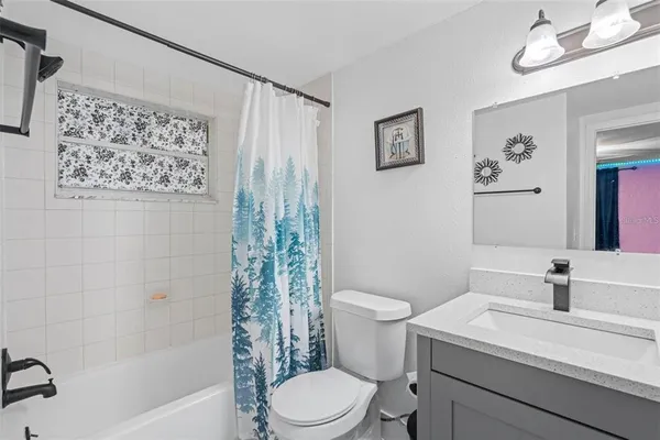 a bathroom with a sink a toilet and a bathtub