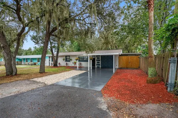 a view of house with backyard and tree