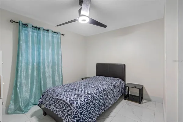 a bedroom with a bed and window