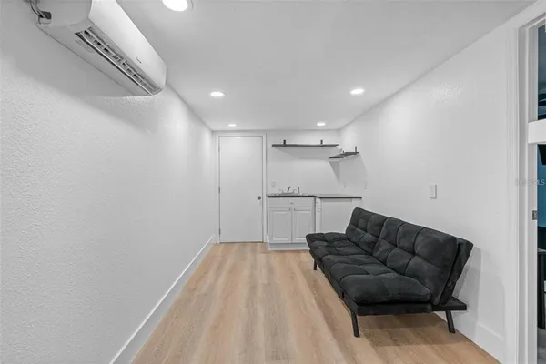 a living room with furniture and a ceiling fan
