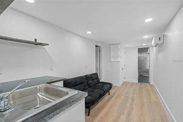 a spacious bedroom with a bed and a sink