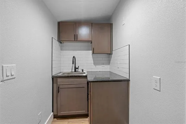 a kitchen with a sink and refrigerator