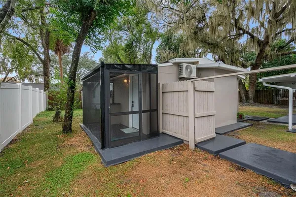 a view of a small house with backyard