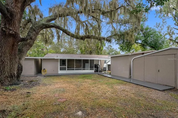 a view of a house with a backyard