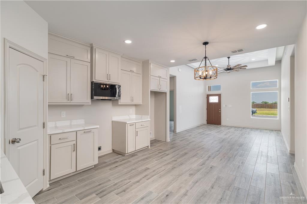2118 Trinity Street Donna, TX 78537 - Photo 13 of 13 a view of a kitchen with a sink and dishwasher a refrigerator with wooden floor