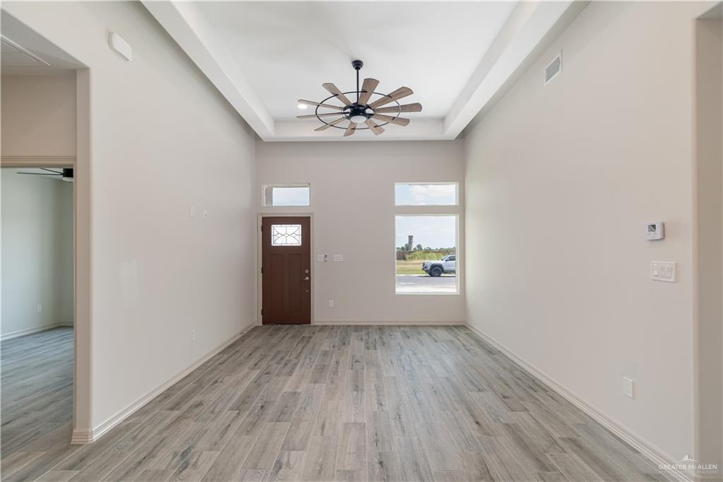 2118 Trinity Street Donna, TX 78537 - Photo 4 of 13 wooden floor in an empty room with a window