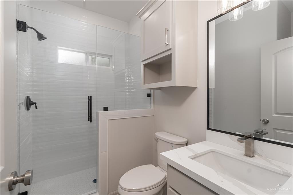 2118 Trinity Street Donna, TX 78537 - Photo 7 of 13 a bathroom with a sink toilet vanity and shower