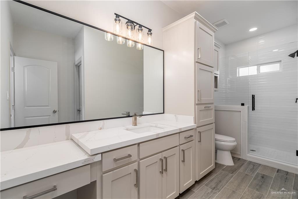 2118 Trinity Street Donna, TX 78537 - Photo 9 of 13 a bathroom with a double vanity sink and mirror