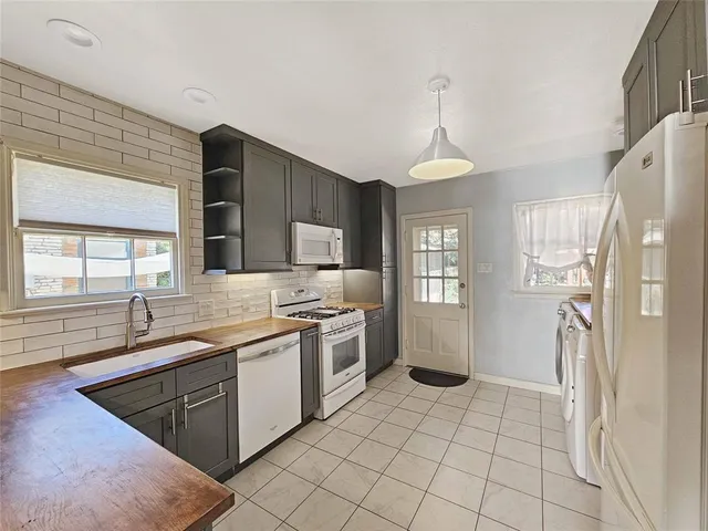 a kitchen with a sink stove and refrigerator
