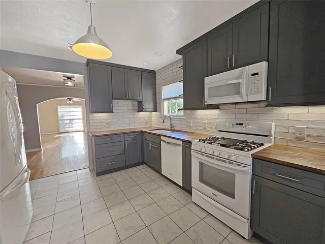 a kitchen with a stove sink and a refrigerator