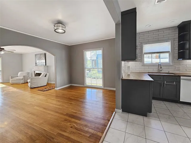 a kitchen with granite countertop a stove a sink and a refrigerator
