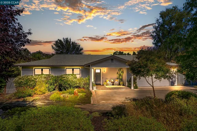 a view of house with yard and green space