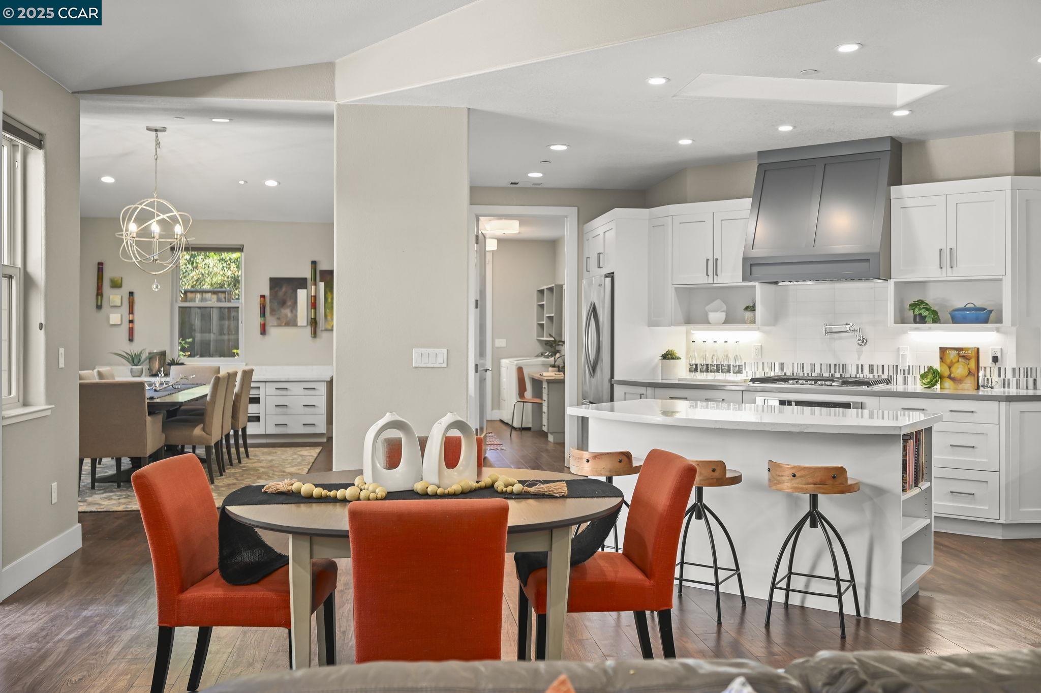 1096 Mountain View Boulevard Walnut Creek, CA 94596 - Photo 11 of 49 a dining hall with stainless steel appliances kitchen island granite countertop a dining table chairs and a refrigerator
