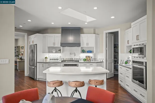a stove top oven sitting inside of a kitchen