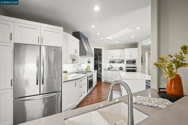 a bathroom with a granite countertop toilet sink and mirror