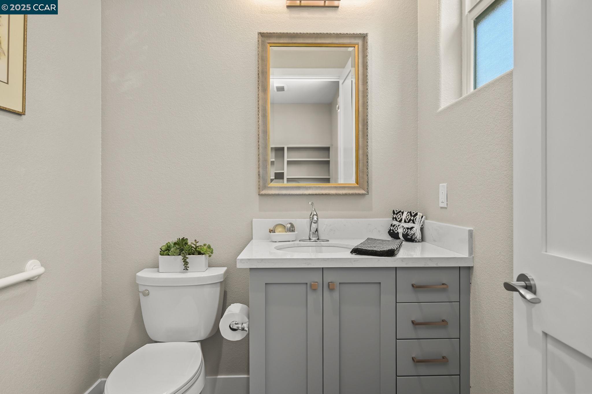 1096 Mountain View Boulevard Walnut Creek, CA 94596 - Photo 21 of 49 a bathroom with a granite countertop toilet sink and mirror