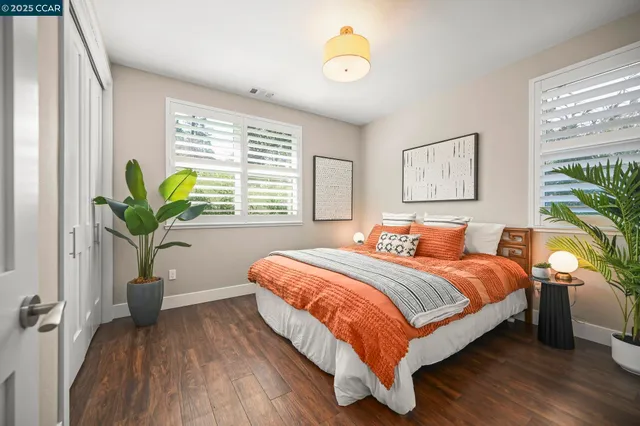 a bed room with a bed and a potted plant