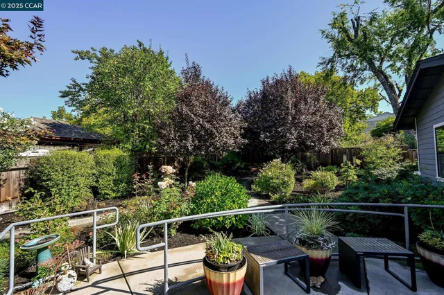 an aerial view of a residential houses with swimming pool and garden space