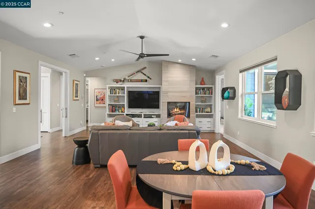 a living room with furniture a ceiling fan and a rug