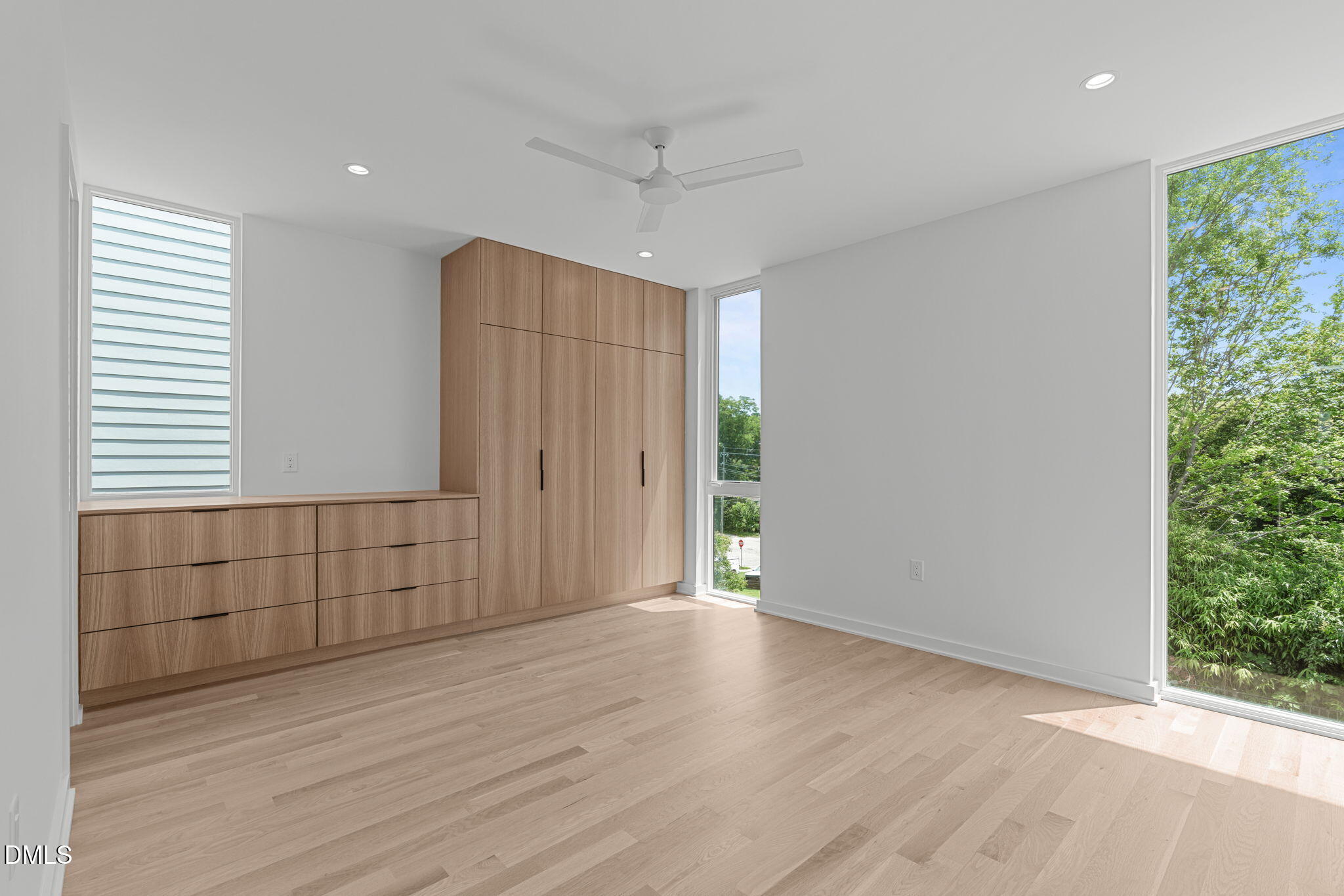 501 South Bloodworth Street, Unit 105 Raleigh, NC 27601 - Photo 21 of 59 an empty room with wooden floor and windows