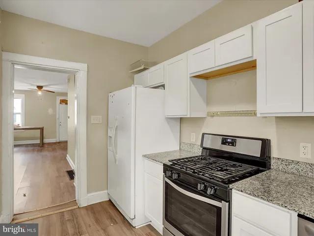 a kitchen with a stove and a refrigerator