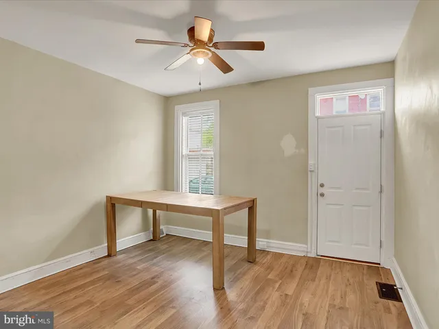 a view of workspace with wooden floor and ceiling fan