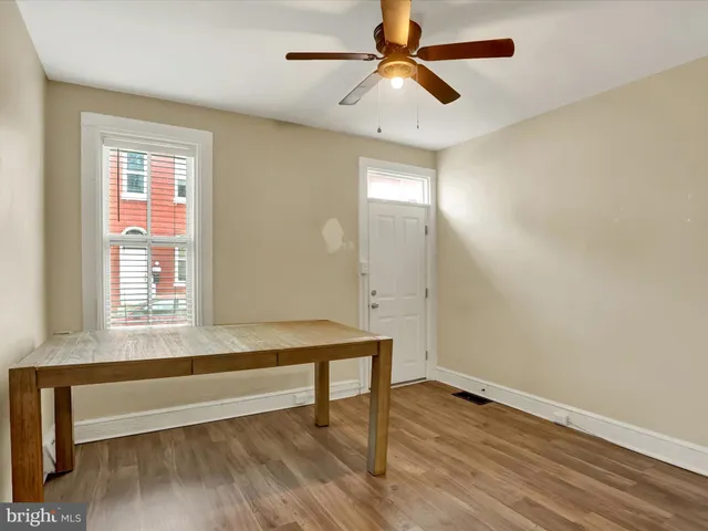 a view of room with window and wooden floor