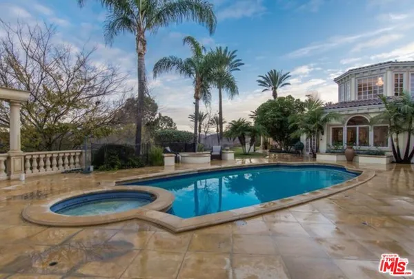 a view of a swimming pool with a patio